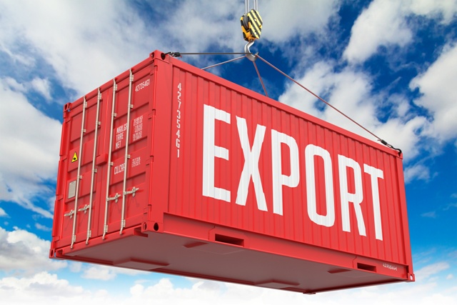 Export – Red Cargo Container hoisted with hook on Blue Sky Background.