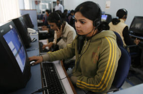 Employees at call centre provide service support to customers in the northeastern Indian city of Siliguri