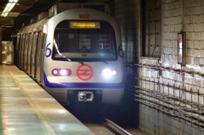 Subway train arrives at metro station of Delhi Metro system