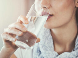 Young woman drinking pure glass of water