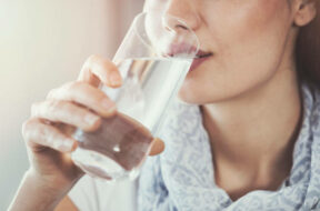 Young woman drinking pure glass of water