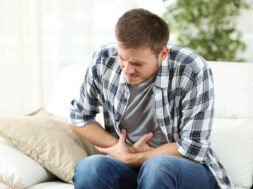Man-In-Living-Room-Has-Stomach-Pain-From-Gastritis