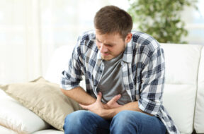 Man-In-Living-Room-Has-Stomach-Pain-From-Gastritis