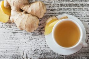 ginger-tea-in-a-white-cup-on-wooden-background-royalty-free-image-492223016-1547048096