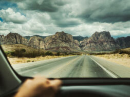 Driving a car on desert highway POV