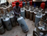 FILE PHOTO: A worker moves a liquid petroleum gas cylinder at a workshop in Karachi,