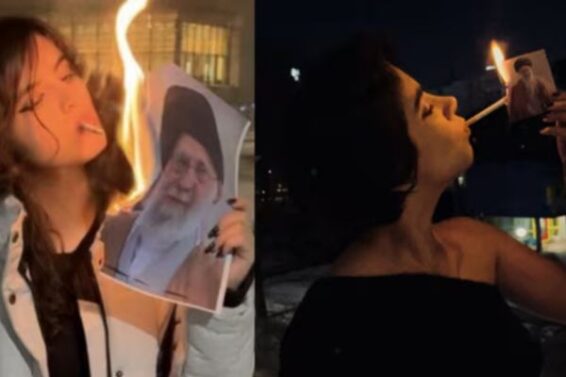 Women light cigarettes with burning posters of Khamenei