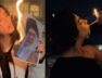 Women light cigarettes with burning posters of Khamenei
